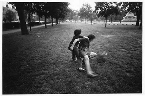 Adrian Piper – The Mythic Being, 1972-1975 - Adrian Piper Getting Back #4, July 1975. B/W photo documentation of a street performance in Cambridge, MA, 10 x 8 in.