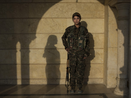 <i>Ocalan's Angel</i>, 2015, Iraq, 110 x 164 cm. Barkhodan Kochar, 16, from Darbasi.
"I joined YPJ in 2014, because I wanted to defend my homeland. The war influenced me a lot. Before joining YPJ, whenever I asked my family about politics, they'd say 'that's not your business, you're just a girl'. But when I saw how the women of YPJ gave their lives for what they believed in, I knew that I wanted to be one of them. I feel much more empowered as a woman now. As a 16-year-old girl, I think that I have a very important role in my country and I will keep on fighting until the last drop of my blood is shed."