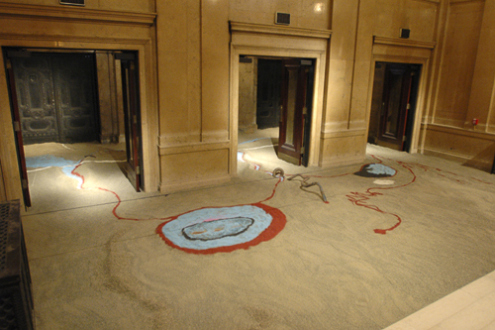 Installation view: Senga Nengudi, From One Source Many Rivers, 2004 - 2005. Sand, pigment, fossils, tape, irrigation tubing.