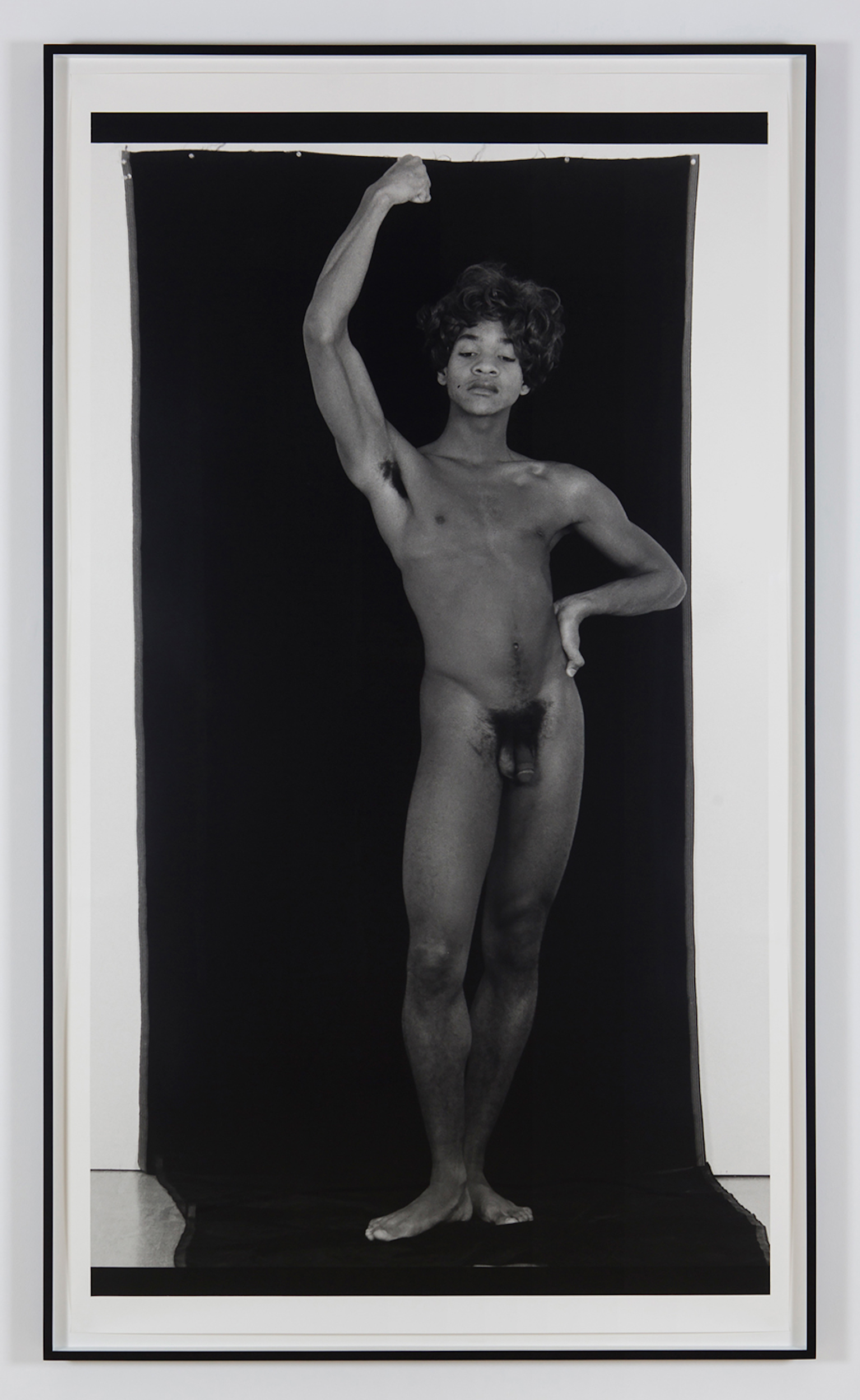 Thomas Erben Gallery – 25 years - Lyle Ashton Harris, <i>Constructs #12</i>, 1989. B/W silver gelatin print, edition of 3, 72 x 48 in.
<br></<br><br></<br>
Lyle Ashton Harris’s <i>Construct #12</i> from 1987-88 is one of a four-part series that was included in the groundbreaking exhibition “Black Male: Representations of Masculinity in Contemporary American Art,” curated by Thelma Golden at the Whitney Museum of American Art in 1994 and which then traveled to the Hammer Museum, Los Angeles, in 1995. This photograph was not part of our 1997 exhibition <i>Lyle Ashton Harris – Early Works 1987-88 (The White Face Series)</i>, but since it reverberates with the representation of “the self” in Adrian Piper’s piece and links to the discussion of queerness in Chitra Ganesh’s <i>Tales of Amnesia</i> (2002/07) as well as Tejal Shah’s video <i>Chingari Chumma (Stinging Kiss)</i> (2000), we decided to include it nonetheless.